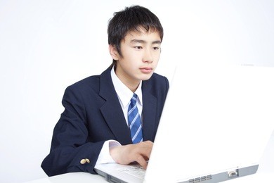 junior high-japanese school boy heading towards the laptop