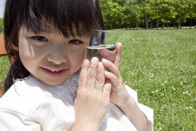 japanese girl's cheek in contact with a cup