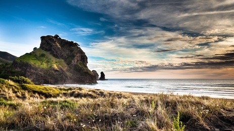 beatiful sunset on piha beach, new zealand