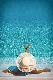 woman sitting on the stairs of a luxury five stars  spa resort  swimming pool. 