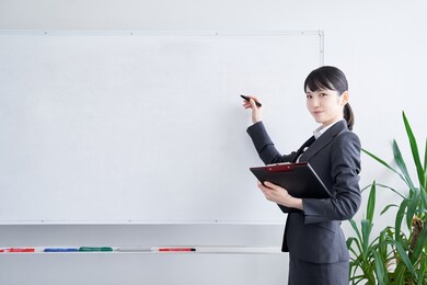 japanese woman writing on a whiteboard