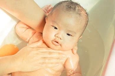 take a bath for a young asian baby
