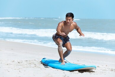 surf man on surfboard.man in sea during surfing healthy active lifestyle in summer vocation.