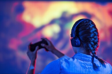 gamer girl playing in front of a big tv, screen in games, e-sports, gamer, streamer, streaming games