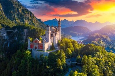 aerial view of neuschwanstein castle with scenic mountain landscape near fussen, bavaria, germany. neuschwanstein castle at sunset, germany. neuschwanstein castle one of the most popular palace.