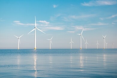 offshore windmill park with stormy clouds and a blue sky, windmill park in the ocean. netherlands europe