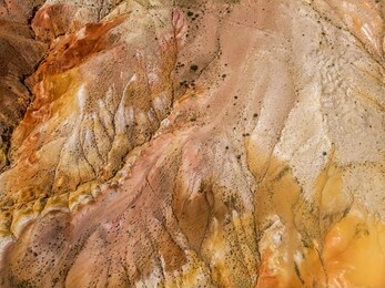 aerial drone view of colorful eroded landform of altai mountains with yellow, brown and red colors. nature landscape in popular tourist location called mars, near the border with mongolia, chagan-uzun