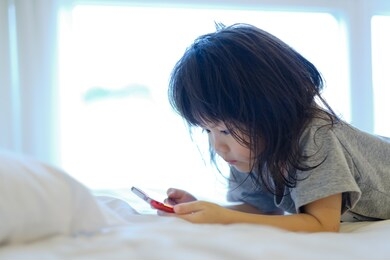 asian chinese child playing smartphone, children watching cartoon, kid use phone
