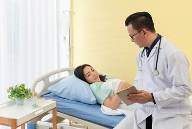 doctor visit asian woman patient who is sick and hospitalized in medicine ward. healthcare and medical concept