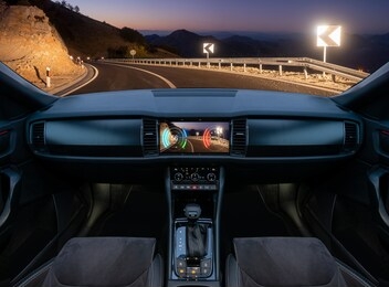 autonomous car driving at night on a winding mountain road