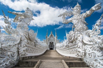 beautiful ornate white temple located in chiang rai northern thailand. wat rong khun (white temple), is a contemporary unconventional buddhist temple.