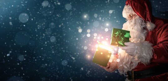 curious santa claus opening magic gift box with copy space