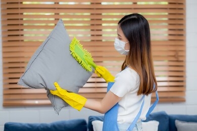 young asian woman cleaning dust.