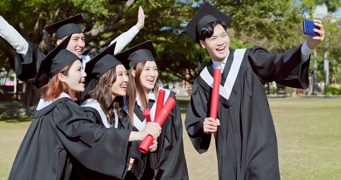 group happy graduate students use mobile phone to take picture together
