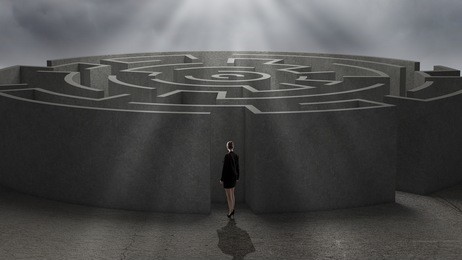 rear view of businesswoman standing near labyrinth entrance