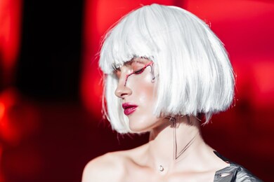 blonde on a red background with stylish clothes. fashion 2021. cyberpunk style