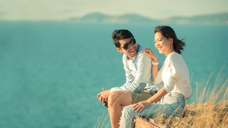 asian younger couples relaxing at sea side
