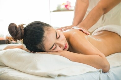 spa,wellness, beauty,self healthcare, relaxation concept. beautiful young asian woman having exfoliation treatment in spa,relaxed woman enjoying oil scrub massage at spa salon.thai massage for health.