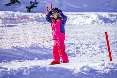 little girl is learning to ski in ski resort. winter season. 