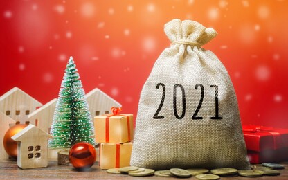 money bag 2021, christmas tree, miniature houses and gifts. new year or xmas winter holiday. accumulating money and planning a budget. business and finance. loans, deposit, credit. promotions, offers