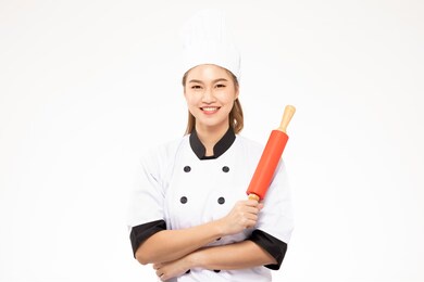 beautiful asian chef woman smile and holding rolling pin isolated on white background,happiness and cheerful professional chef concept