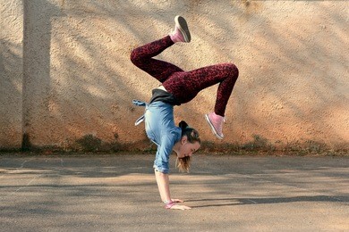 young girl dancing breakdance on the street