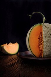 isolated, copy space, selective focus of sliced of japanese melons/honey melon/cantaloupe on the wooden table.  