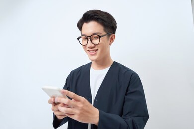 young handsome asian man using mobile phone