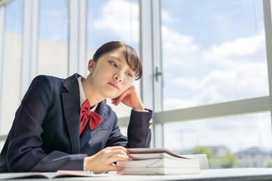 asian female high school student studying in classroom.