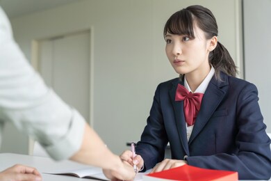 asian female high school student and teacher in classroom. cram school. preparatory school. home tutor.