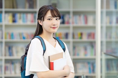 asian female student standing in library.