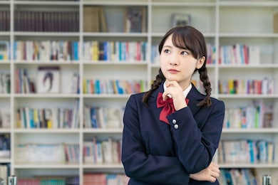 thinking asian female high school student.