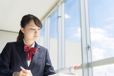 asian female high school student studying in classroom.