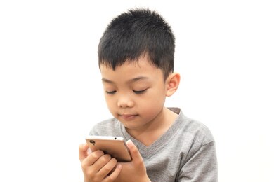 portraits of asian boy with playing smartphone on white background, happy time