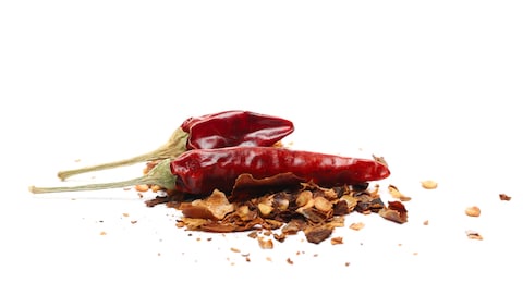 dry spicy chili peppers with flakes, powder isolated on white background