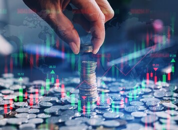 businessman holding coin with  graph. double exposure of financial graph.technical price candlestick chart graph and indicator stock online trading. forex investment business.