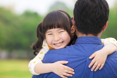 happy little girl hugging embracing her father