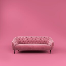 fashionable comfortable stylish pink fabric sofa with black legs on pink background with shadow. pink interior, showroom, single piece of furniture. vilyura, velvet sofa. luxury couch front view