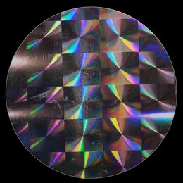 macro top shot photo of holographic foil sticker with cool grid pattern texture, holo sticker on real paper sheet isolated on black background with nice light reflections and scratches.