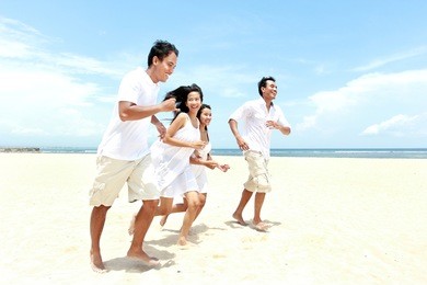 group of young friends enjoying beach together