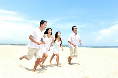 group of young friends enjoying beach together