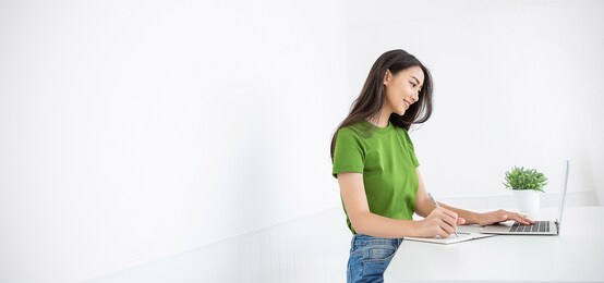 portrait of smile beautiful business asian woman in green casual t-shirt working in office desk computer. small business people employee freelance online sme marketing e-commerce telemarketing concept