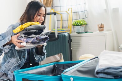 women organize her luggage prepare stuff for travel.