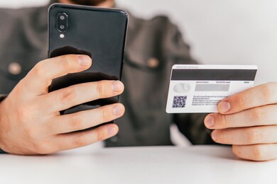 buying online with a credit card and smart phone sitting home with a blurred background. hand credit card for shopping online