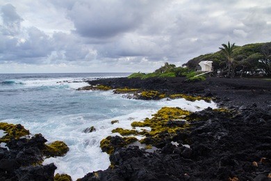 lifeguard tower on black sand beach