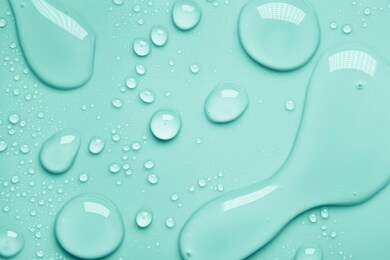 cosmetic moisturizing liquid drops on green blue pastel background. toner or lotion. hyaluronic serum