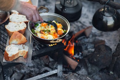 fried egg in a camping pan on camping fire