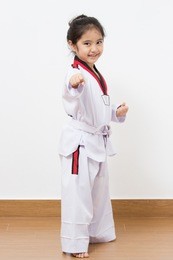 little asian taekwondo child in fighting action