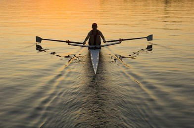 single rower at sunrise