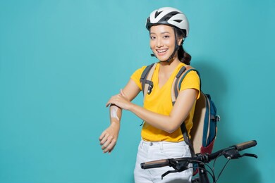 beautiful asian women she is cycling in the sun. she applied the cream and lotion.studio concept